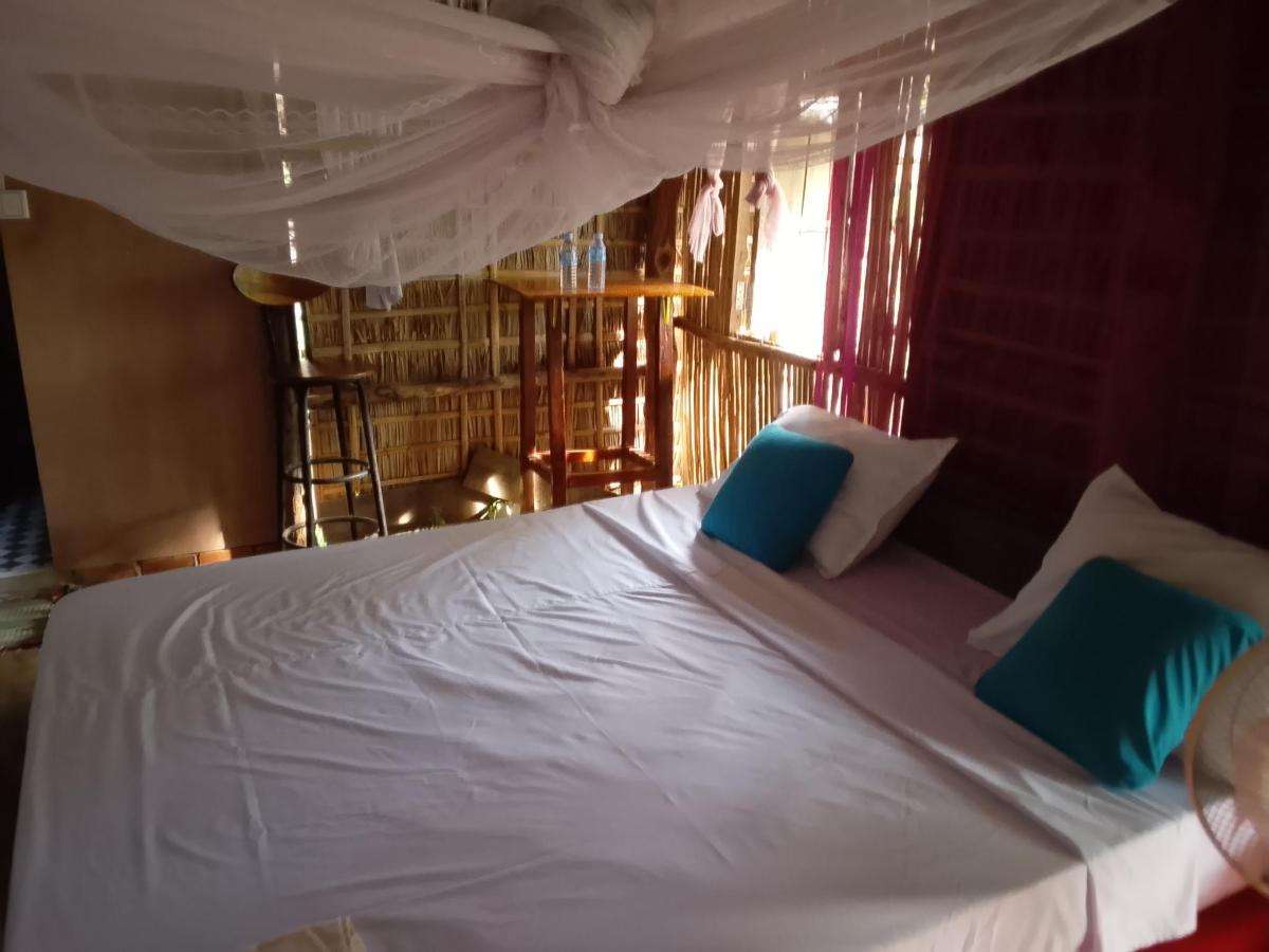 Family Bungalow bedroom with two queen beds and mosquito nets